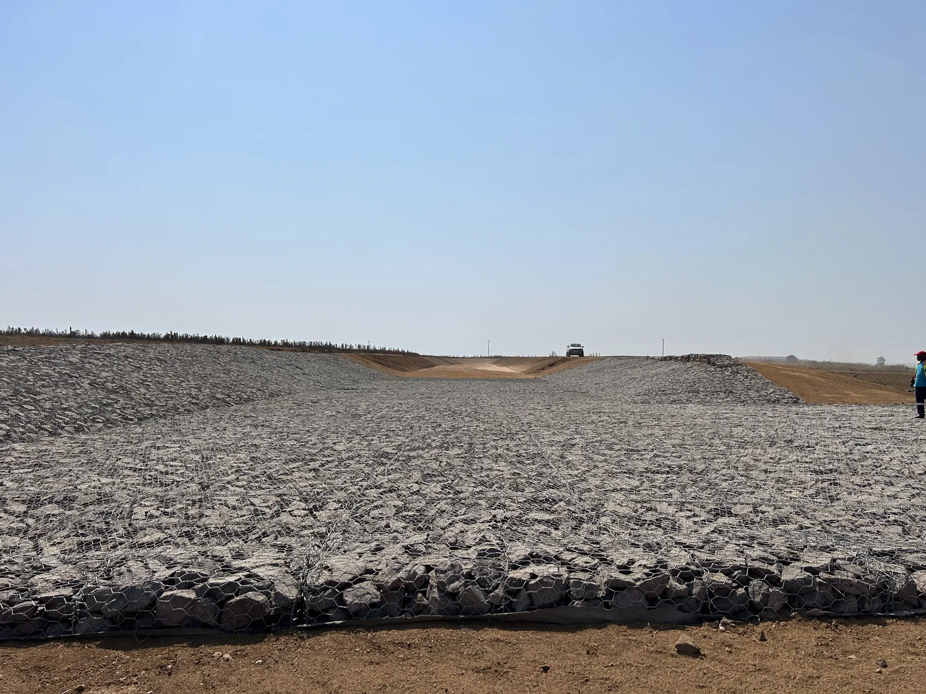 Newly installed Reno mattress lining a wide drainage channel on a dry Highveld site.