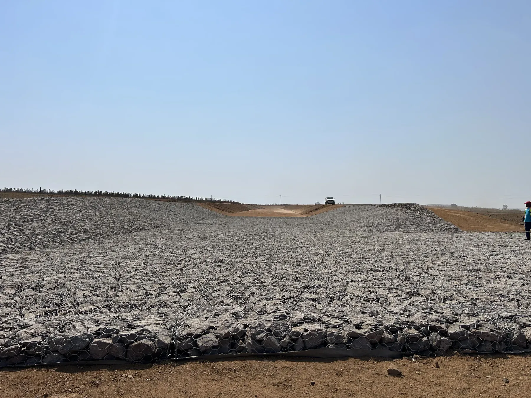 Newly installed Reno mattress lining a wide drainage channel on a dry Highveld site.