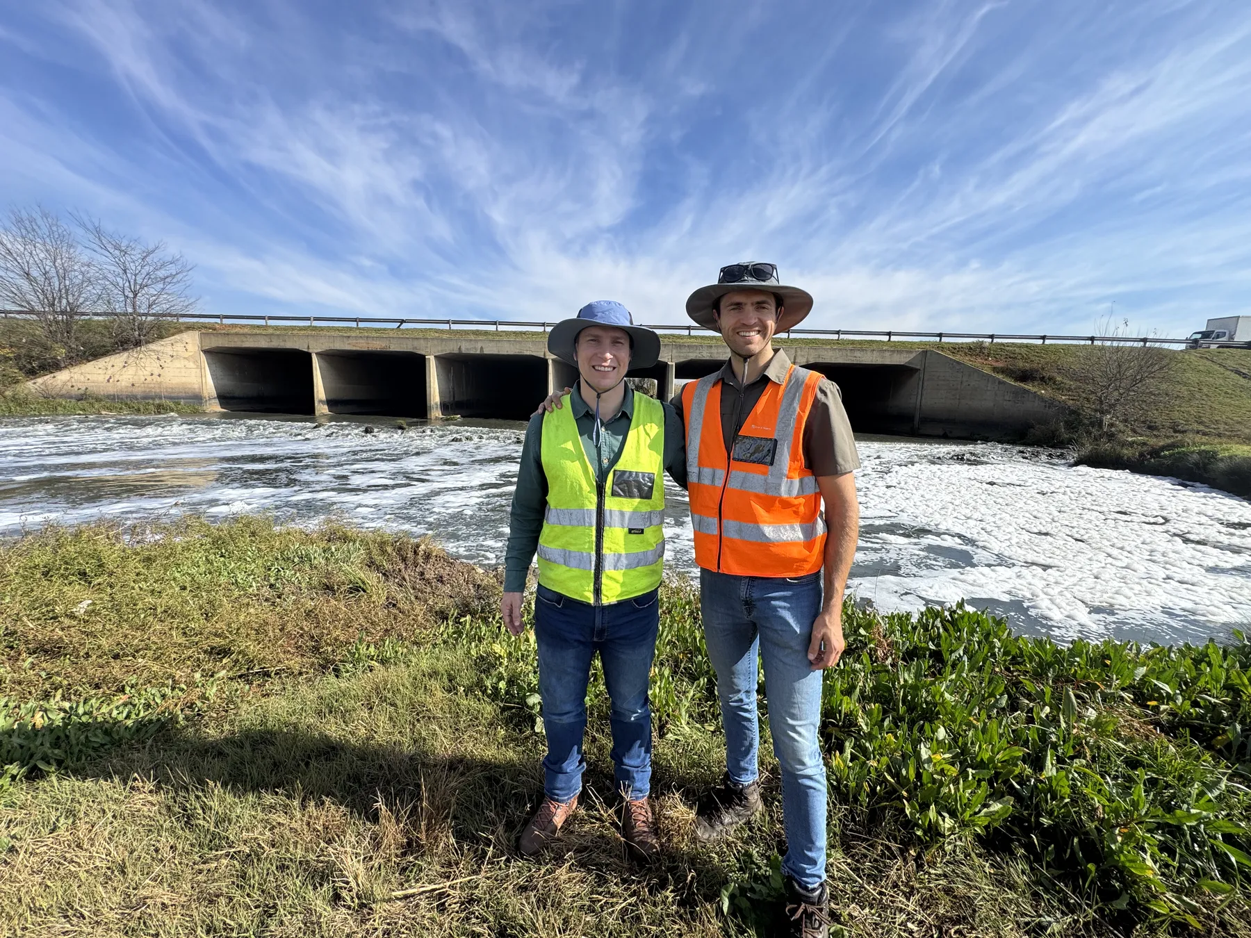 Robert Fortuin and Stephan Dreyer, Delta Hydro Engineers co-founders, standing together in hi-vis vests at a box culvert site inspection.